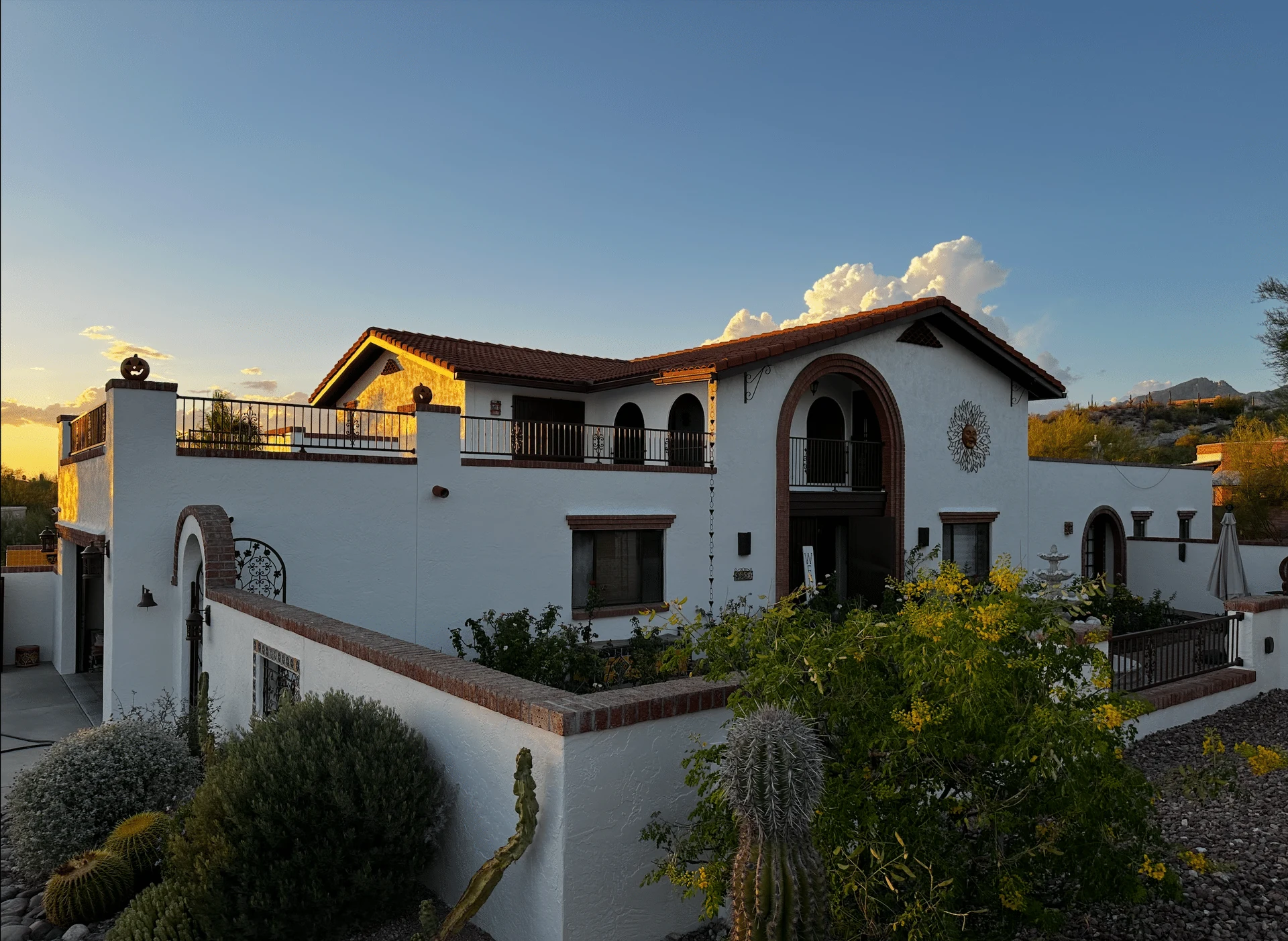 Freshly painted white Spanish-style Tucson home at sunset