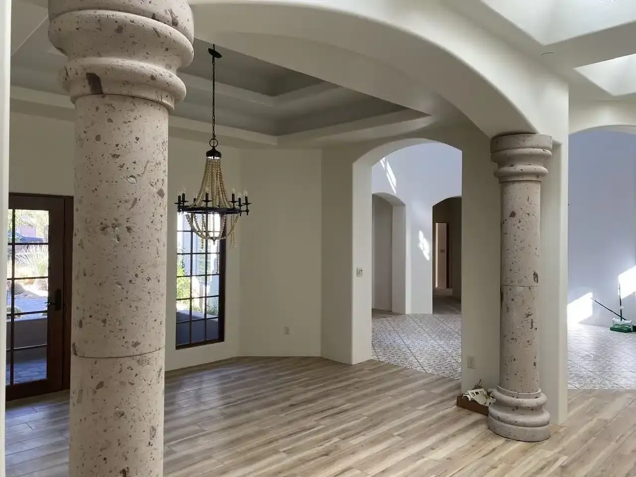 Freshly painted Tucson home interior with arched stone columns